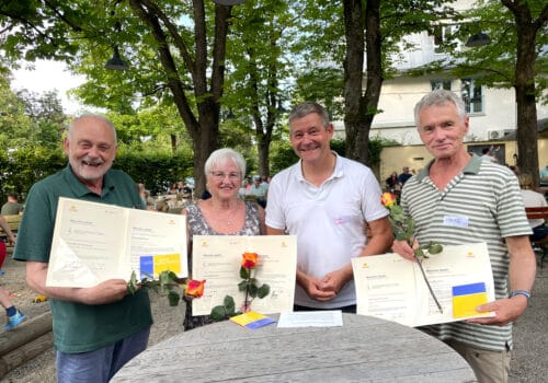 Drei Lesefüchse werden vom Vorsitzenden mit "München dankt" geehrt.